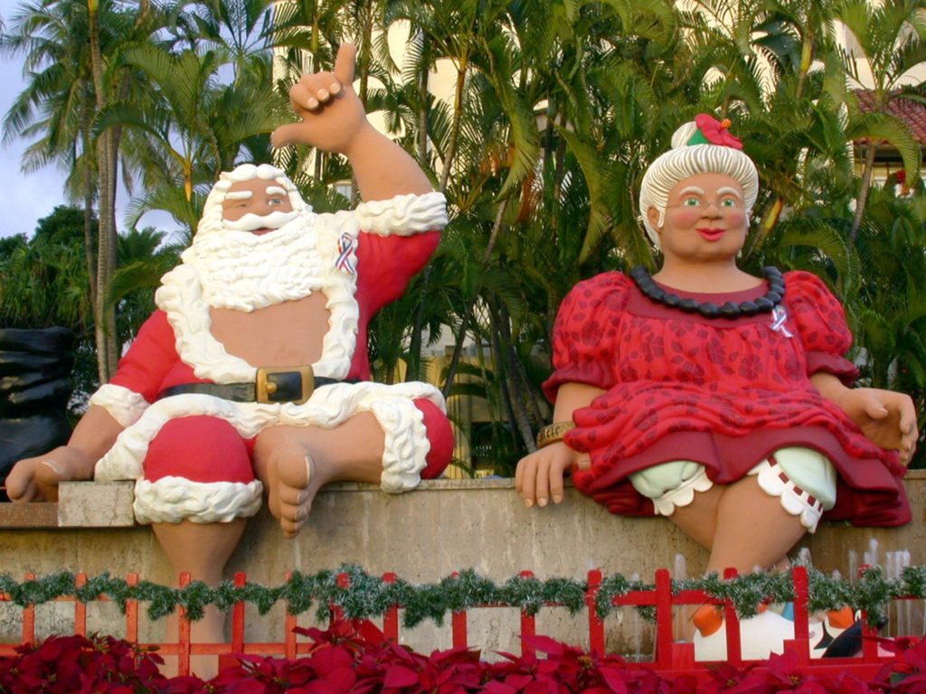 Shaka Santa and Tūtū Mele greet you at Honolulu City Lights.